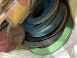 a man that is holding a bunch of different colored tapes