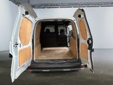 a white van with its doors open in a room