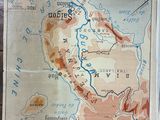 a map on the table with a person standing next to it