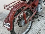 a red motorcycle parked on the side of the street