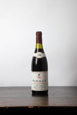 a bottle of wine sitting on a wooden table