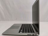 an open laptop computer sitting on top of a white table