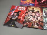 four star wars books are lined up on a table