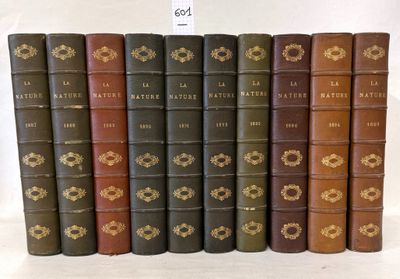 several old books are lined up in a row on a white surface