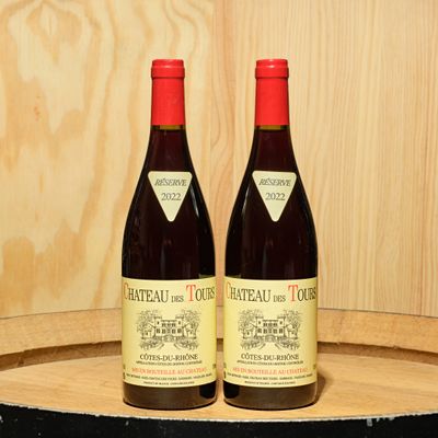 two bottles of wine sitting on top of a barrel