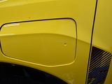 a close up of a yellow car door handle
