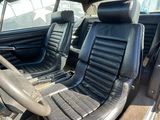 une photo de l'intérieur d'une voiture avec des sièges en cuir noir