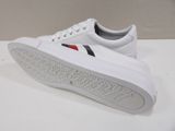 white sneakers with red, blue, and white stripes on the sole