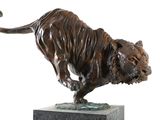 bronze sculpture of a tiger on a marble base