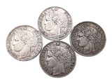 four different types of silver coins on a white background