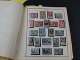 an open book with stamps on it sitting on a table