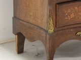 a small wooden chest of drawers with a clock on top of it
