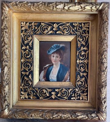 painting of a woman in a blue hat with a pipe in a gold frame