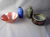 three bowls and a bowl sitting on a table