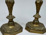 pair of antique brass candlesticks on a white background