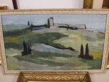 a painting of a landscape in a gold frame on a table