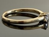 a gold ring with a diamond on top of it