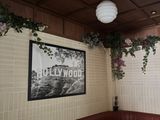 a picture of a dining room with a table and a picture on the wall
