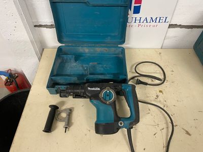 a blue drill sitting on top of a table next to a tool box