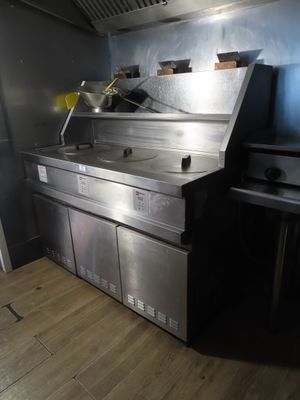 a large stainless steel kitchen with a stove and a sink