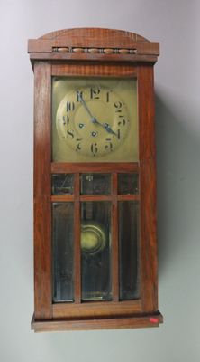 a wooden clock hanging on the wall in the room