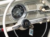 steering wheel and dashboard of a classic car with a clock on the dash