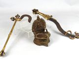 brass figurine of a hindu god with a staff and a snake