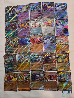 a pile of pokemon cards sitting on top of a table