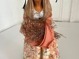 figurine of a woman with a basket of flowers in her hand