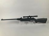 a rifle with a scope on a white background