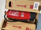a red fire extinguisor sitting on top of a cardboard box