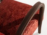 a close up of a red chair on a white surface