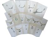 many different types of jewelry on display in a display case
