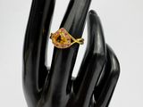 a black hand with a gold ring on it