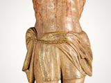 statue of jesus on the cross with blood all over his body