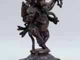 a bronze statue of the hindu god ganesha on a pedestal