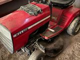 a red lawn mower parked in a garage