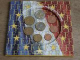 a picture of a book with a picture of a flag and coins on it