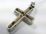 sterling silver cross pendant on a silver chain on a white background