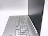 a silver laptop computer sitting on top of a white table