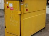 a yellow dumpster that is sitting in the dirt