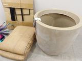 a planter and a towel on the floor next to a box
