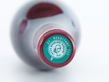 a close up of a bottle of wine on a white surface