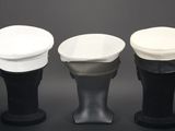 three hats are lined up on top of each other on a black surface