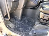 a close up of the inside of a car with a black floor mat
