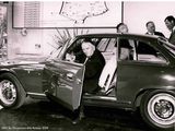 black and white photo of a man getting out of a car