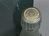 a bottle of champagne sitting next to a green box