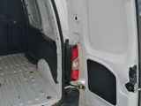 the back of a white van with the door open and the back door open