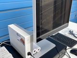 a laptop computer sitting on top of a desk next to a laptop computer