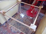 a glass table with a red umbrella on top of it